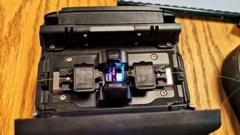 Fiber optic fusion splicer preparing connections for high-speed data Stock Footage 332221559