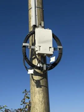 Fiber optic junction box mounted on a wooden utility pole, Gers, Saint Geor.. Stock Photos