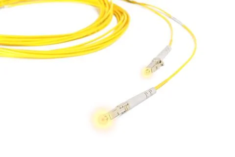 Fiber optic patchcord with lighting effect on white background Stock Photos