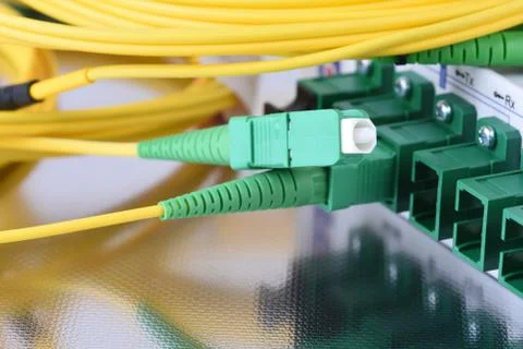 Fiber optical network cables connected to equipment Stock Photos