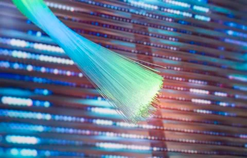Fiber optics network cable on technology background Stock Photos