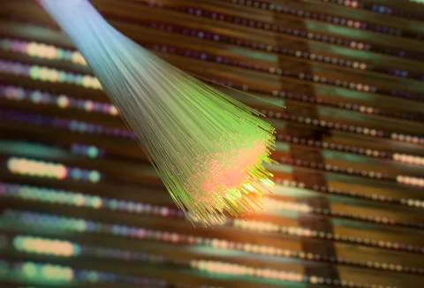 Fiber optics network cable on technology background Stock Photos