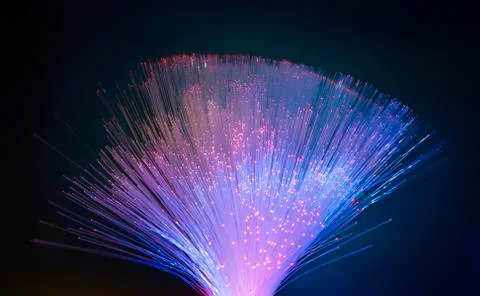 Fiber optics network cable on technology background Stock Photos
