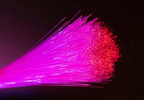 Fiber optics network cable on technology background Stock Photos