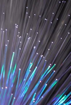 Fiber optics network cable on technology background Stock Photos