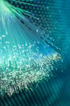 Fiber optics network cable on technology background Stock Photos