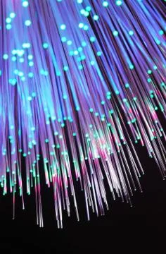 Fiber optics network cable on technology background Stock Photos