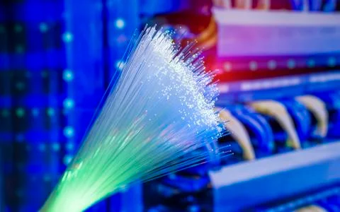 Fiber optics network cable on technology background Stock Photos