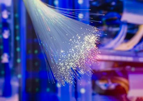 Fiber optics network cable on technology background Stock Photos