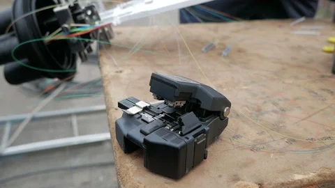Fiber Splicing Tool Machine in use for connecting fiber optic cable Stock Footage 126948188