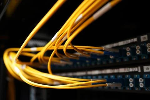 Fibre cables going in to a patch panel Stock Photos