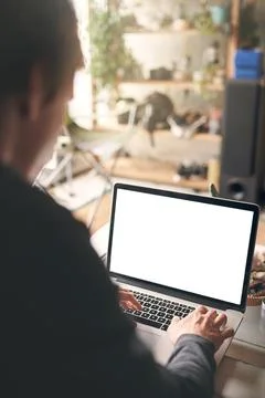 Fibre makes for fast and efficient work. an unrecognisable man using a laptop at Stock Photos