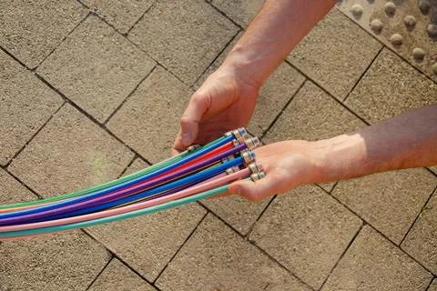 Fibre optic cable in the hands of a man Stock Photos