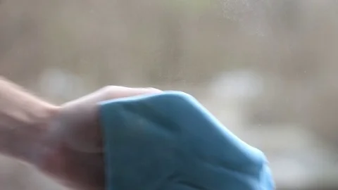 Fibro-rag washing a window outdoors Stock Footage 71978043