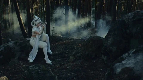 Fictional forest creature satyr with horse-like legs is sitting in gloomy timber Stock Footage 93000433