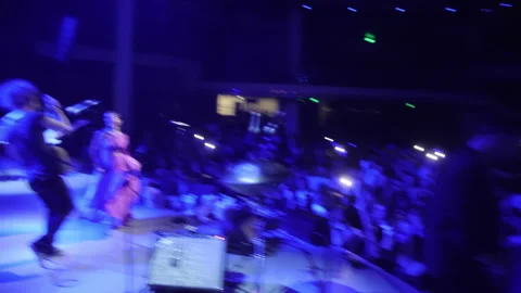 Fiddle player runs onto stage with violin and starts playing Stock Footage 259665350