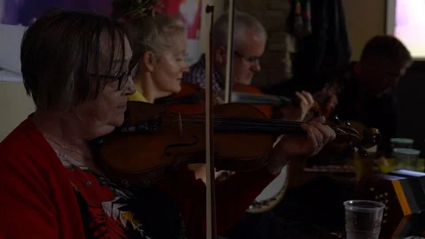 Fiddler playing in a group Stock Footage 127585130