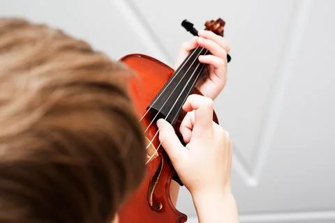 Fiddlestick on the strings of a violin Pizzicato Stock Photos