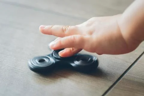 Fidget spinner and child hand Foto stock