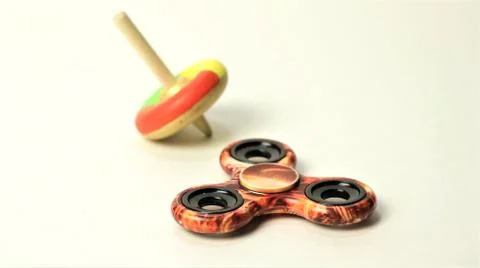 Fidget Spinner and Spinning Top - Out with the Old and In with the New Stock Photos