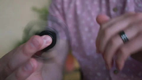Fidget Spinner Held by Man in a Pink Shirt 4K Stock Footage 75919518