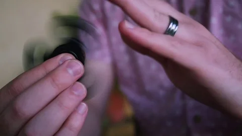 Fidget Spinner Held By A Man in a Pink Shirt 4K Stock Footage 75919520