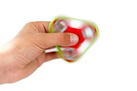 Fidget spinner. Red hand spinner, fidgeting hand toy rotating on child's hand Stock Photos