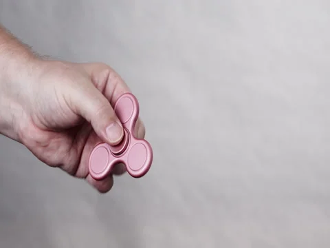 Fidget spinner rotating on human hand 4K Stock Footage