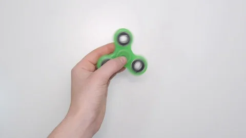 Fidget Spinner Spinning in Hand Overhead Stock Footage 100645674