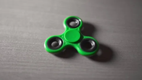 Fidget spinner is twisting round and round, toys for everyone Stock Footage 80036848