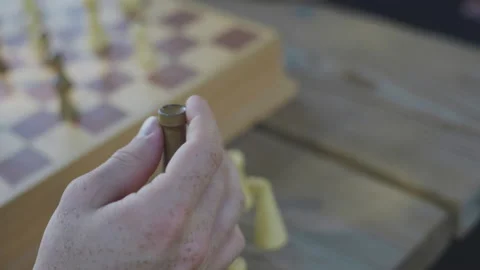 Fidgeting with chess piece Stockbeeldmateriaal 171721371