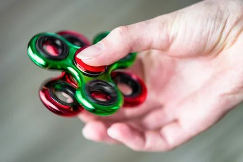 Fidgets spinner in hand Stock Photos