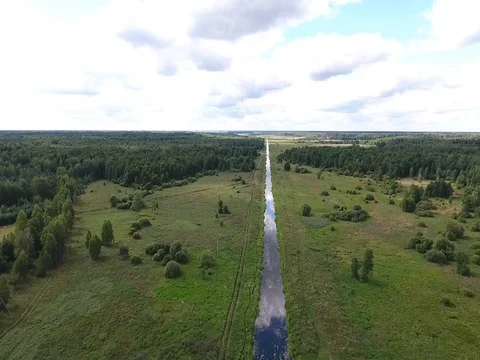 Field along the river and the forest  Stock Footage 70347576