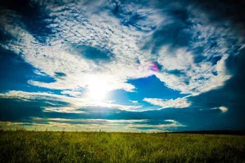 Field and sunset sky Stock Photos