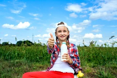 In the field the child eats Stock Photos