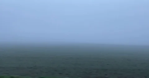 Field covered by fog along railway Stock Footage