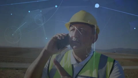 Field engineer holding phone to ear, starting wind farm check while using AR Stock Footage 319683588