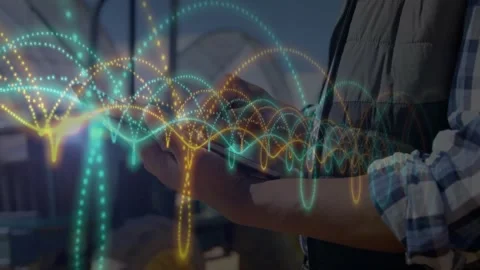 Field engineer tapping tablet and animating layered data waves for real time Video stock 325706553