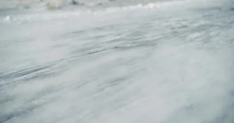 Field enveloped in snow during a cold winter day, as strong winds cause drift Video stock 309885520