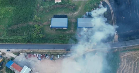 Field fire is burning in the distance, with smoke rising into the sky. The sc Stock Footage 296845347