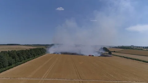 Field on fire with firefighters (drone) Stock Footage 92080521