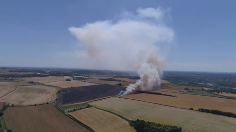 Field on fire with firefighters (drone) Stock Footage 92083321