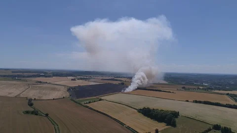 Field on fire with firefighters (drone) Stock Footage 92083491