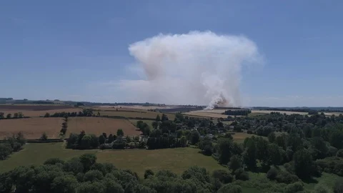 Field on fire with firefighters (drone) Stock Footage 92083518
