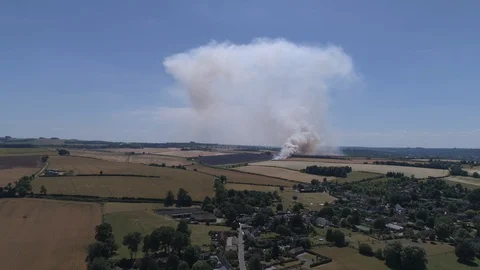 Field on fire with firefighters (drone) Stock Footage 92084317