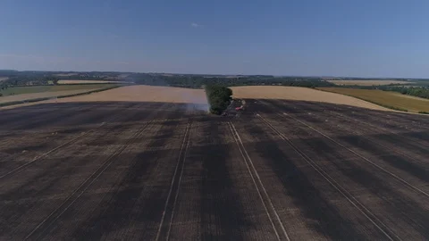 Field on fire with firefighters (drone) Stock Footage 92085113