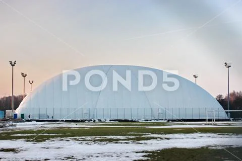 Field for football or tennis in the winter time. stretched awning for protect Stock Photos