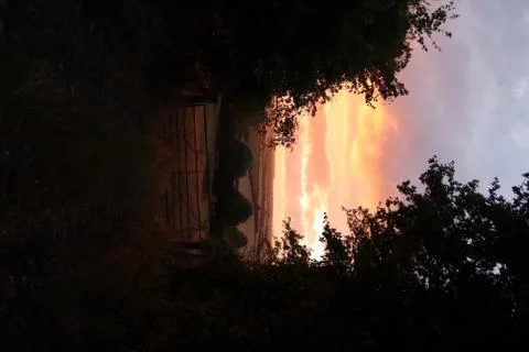 Field gate with sunset behind Stock Photos