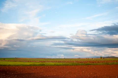 Field landscape with clouds in the sky Stock Photos