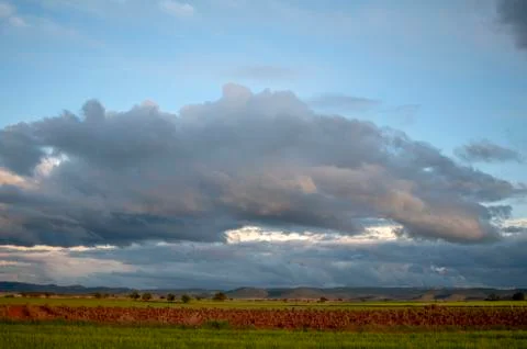 Field landscape with clouds in the sky Stock Photos